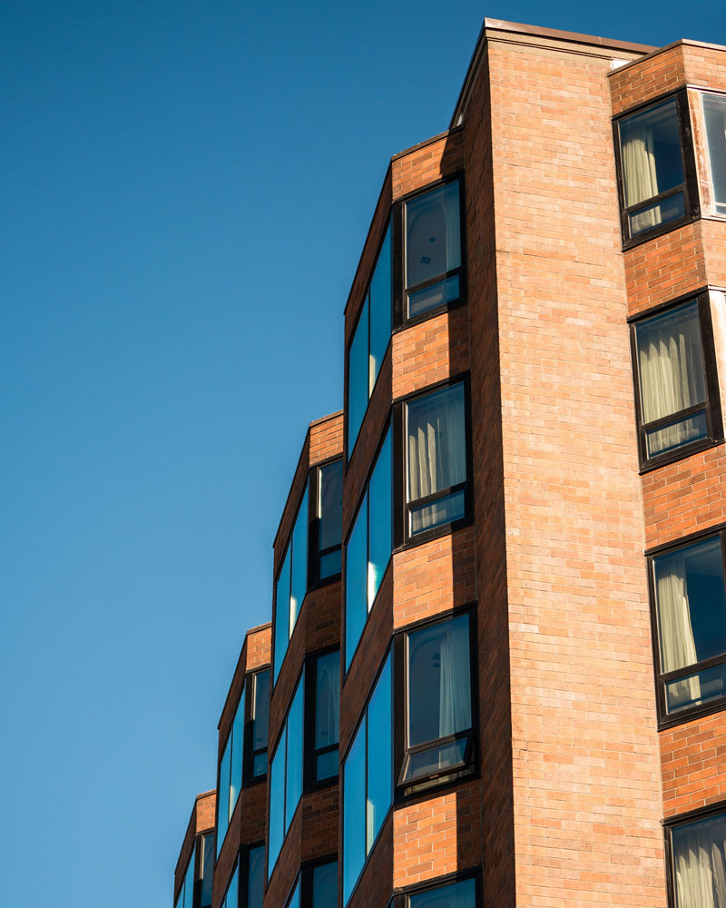 image of modern apartment building set in front of a blue sky